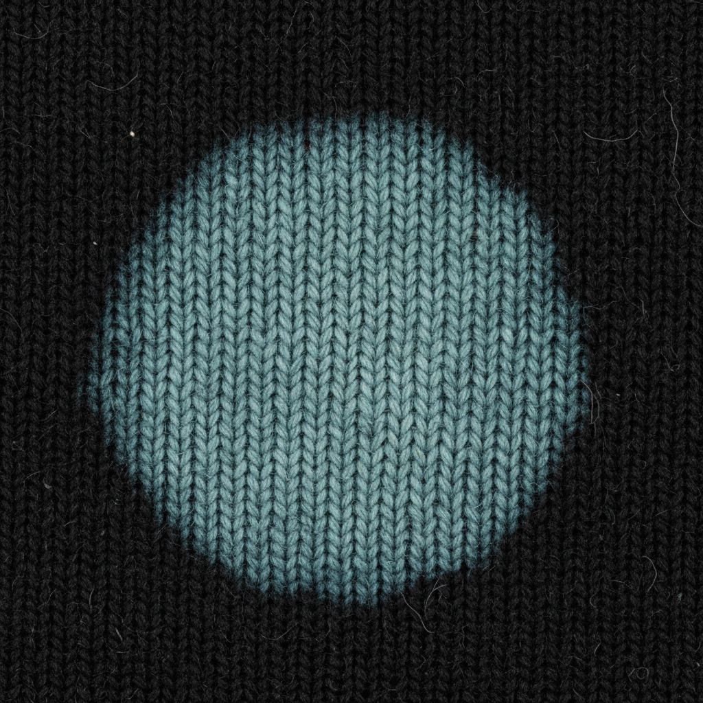 Extreme macro of discharge print area showing zero ink film, color living inside cotton fiber