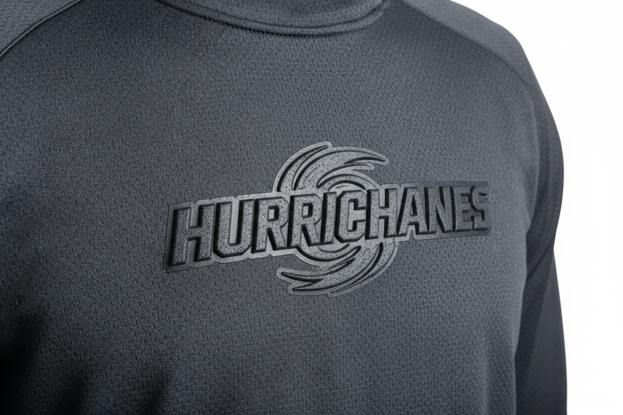 Athletic performance pullover with raised HSA-printed team logo, directional shadow revealing relief