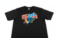 Studio flat-lay of a finished screen-printed black t-shirt with bold multicolor sports graphics on a white background