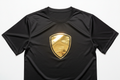 Black performance tee with gold foil shield logo, mirror surface catching studio light