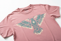 Pigment-dyed vintage tee with faded two-color water-based chest print absorbed into fabric weave